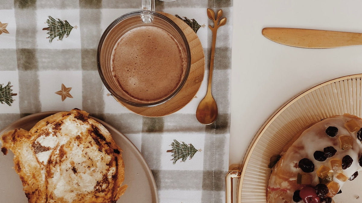 Coffee and festive bread on a Christmas-patterned breakfast table linen