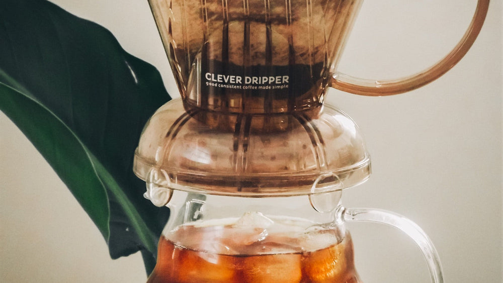 A Clever Dripper brewing coffee over a glass carafe