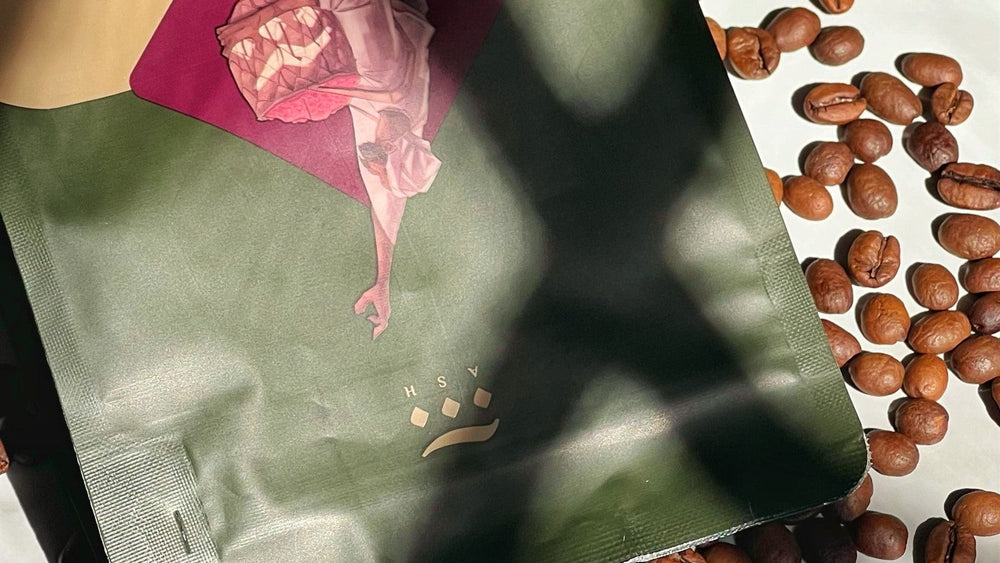 Sunlit coffee bag surrounded by roasted coffee beans