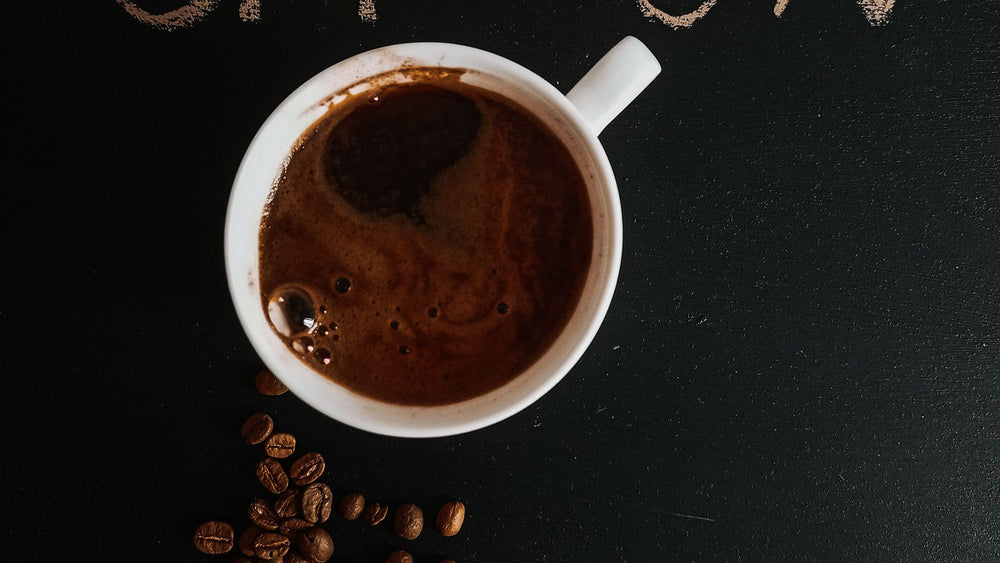 Coffee cup surrounded by beans with OFF and ON lettering representing decaf