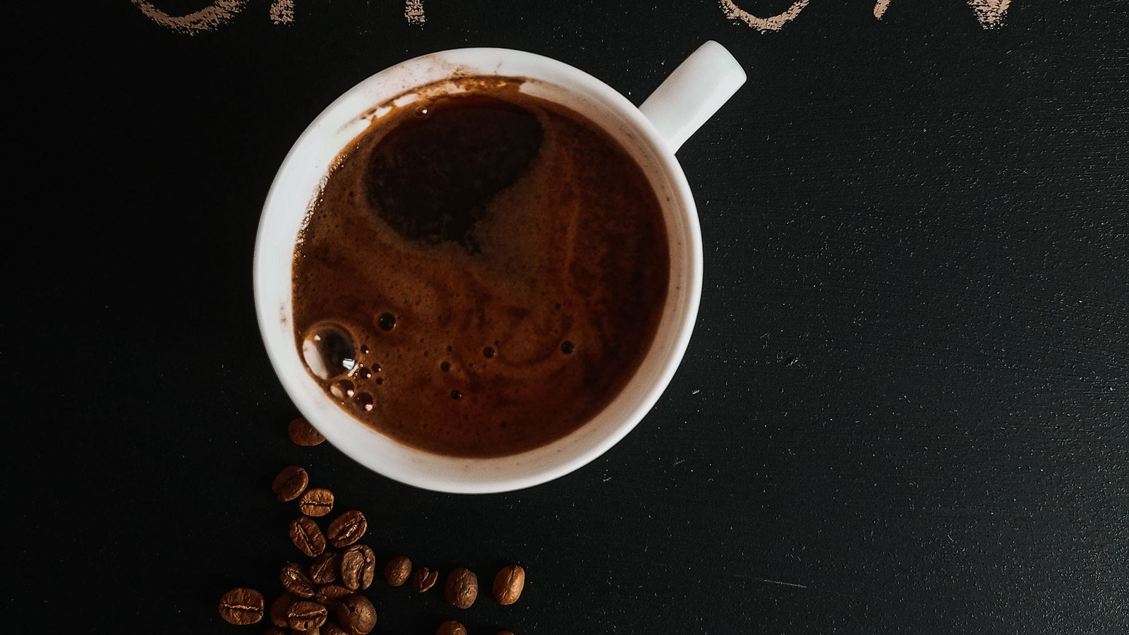 Coffee cup surrounded by beans with OFF and ON lettering representing decaf