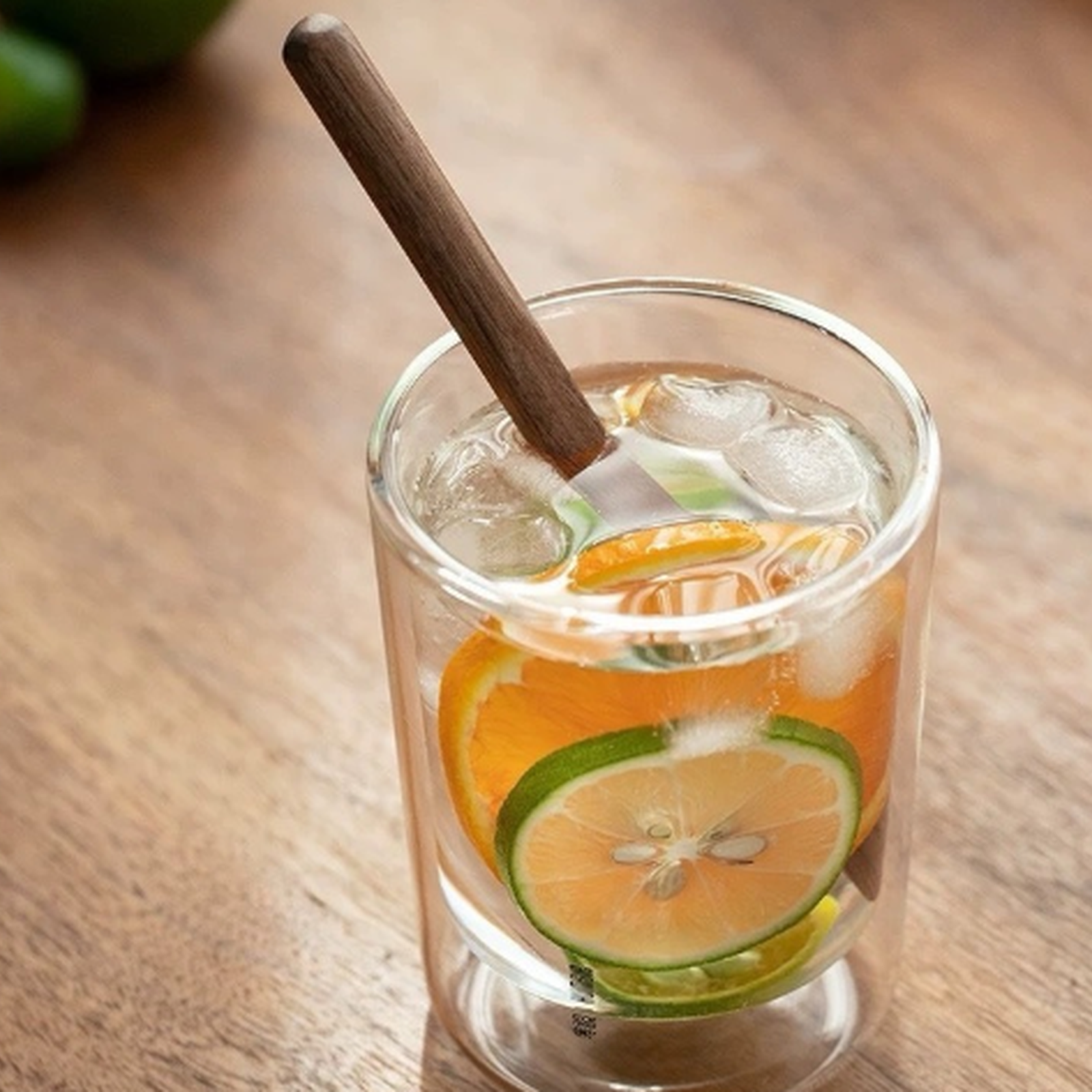 Round black walnut stirrer in a cold citrus drink