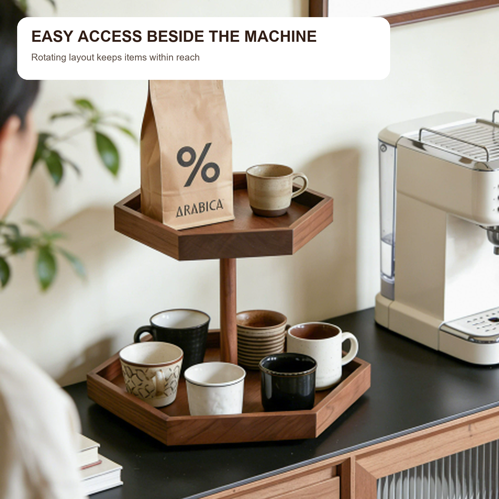 Rotating solid walnut coffee organizer beside an espresso machine