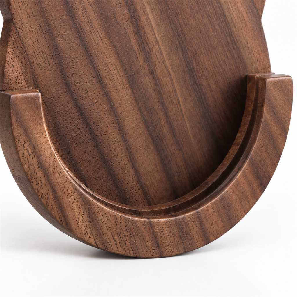 Close-up of the curved wooden cradle on the walnut portafilter holder