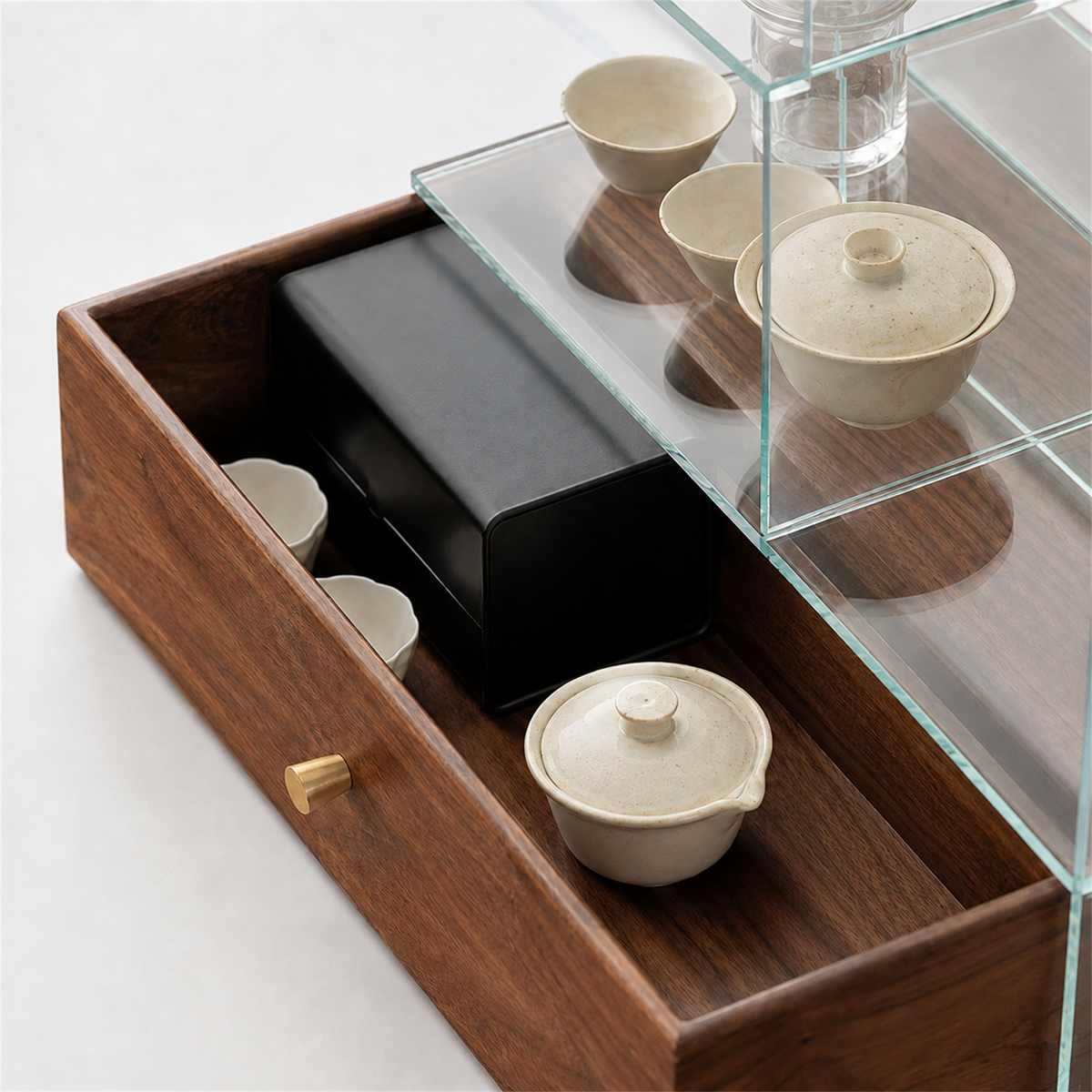 Close-up of the pull-out solid walnut drawer and round metal knob beneath the glass display