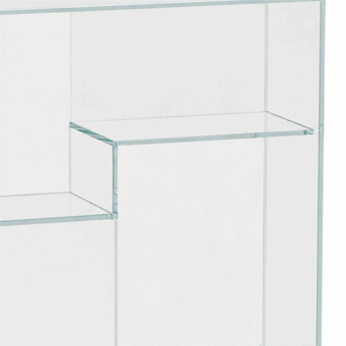 Close-up of staggered clear glass shelves and transparent panel joints