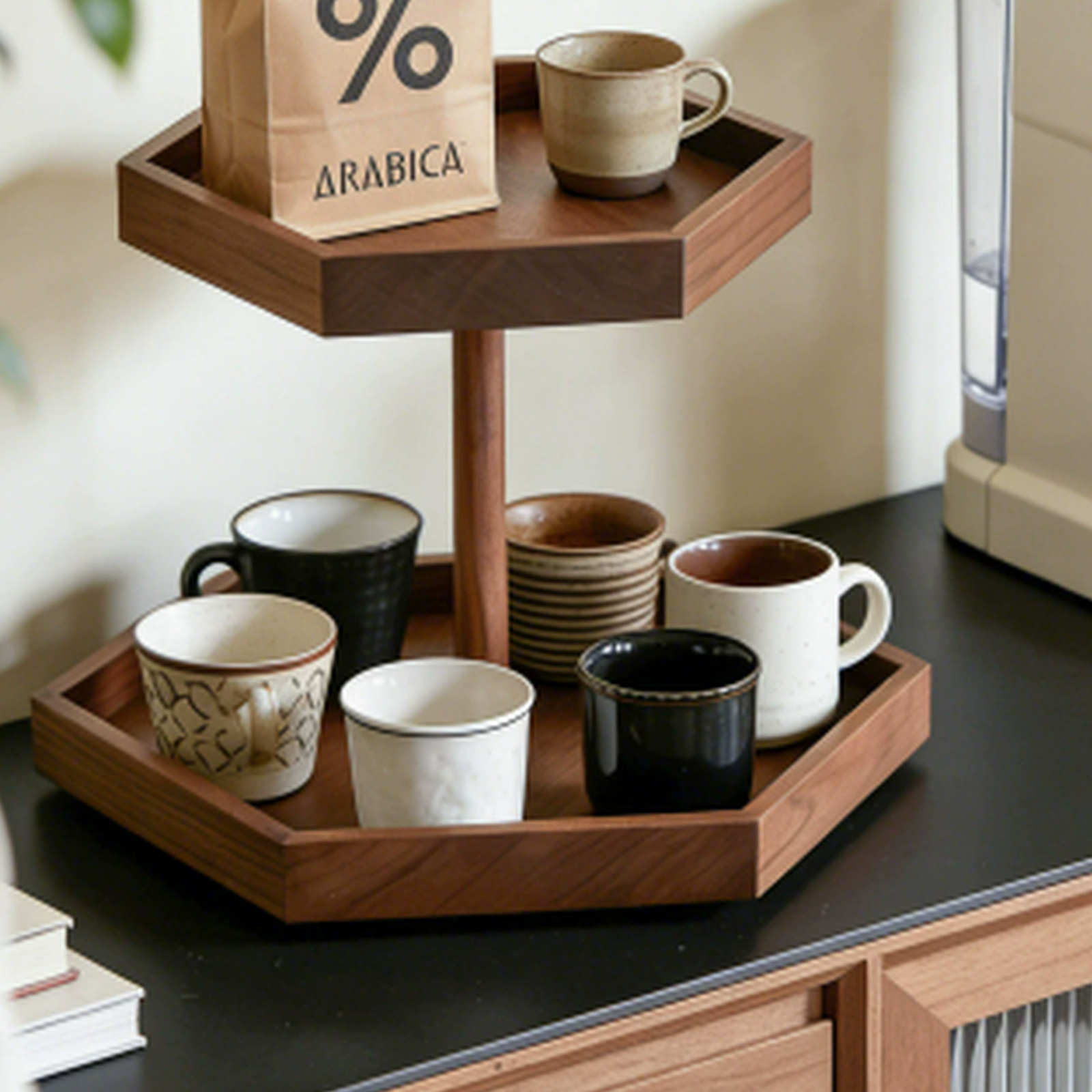 Rotating solid walnut coffee organizer beside an espresso machine