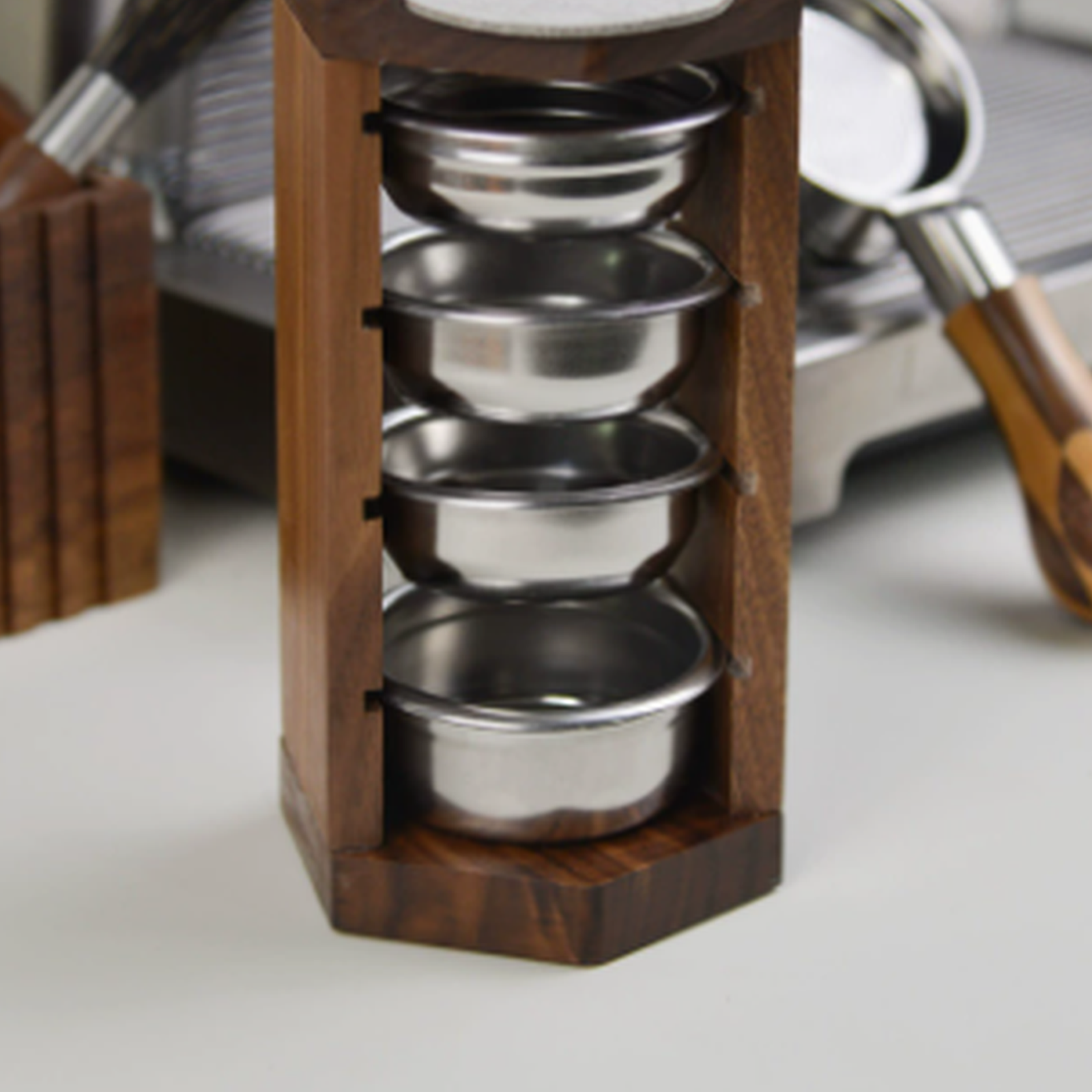 Solid walnut espresso basket organizer beside a coffee machine