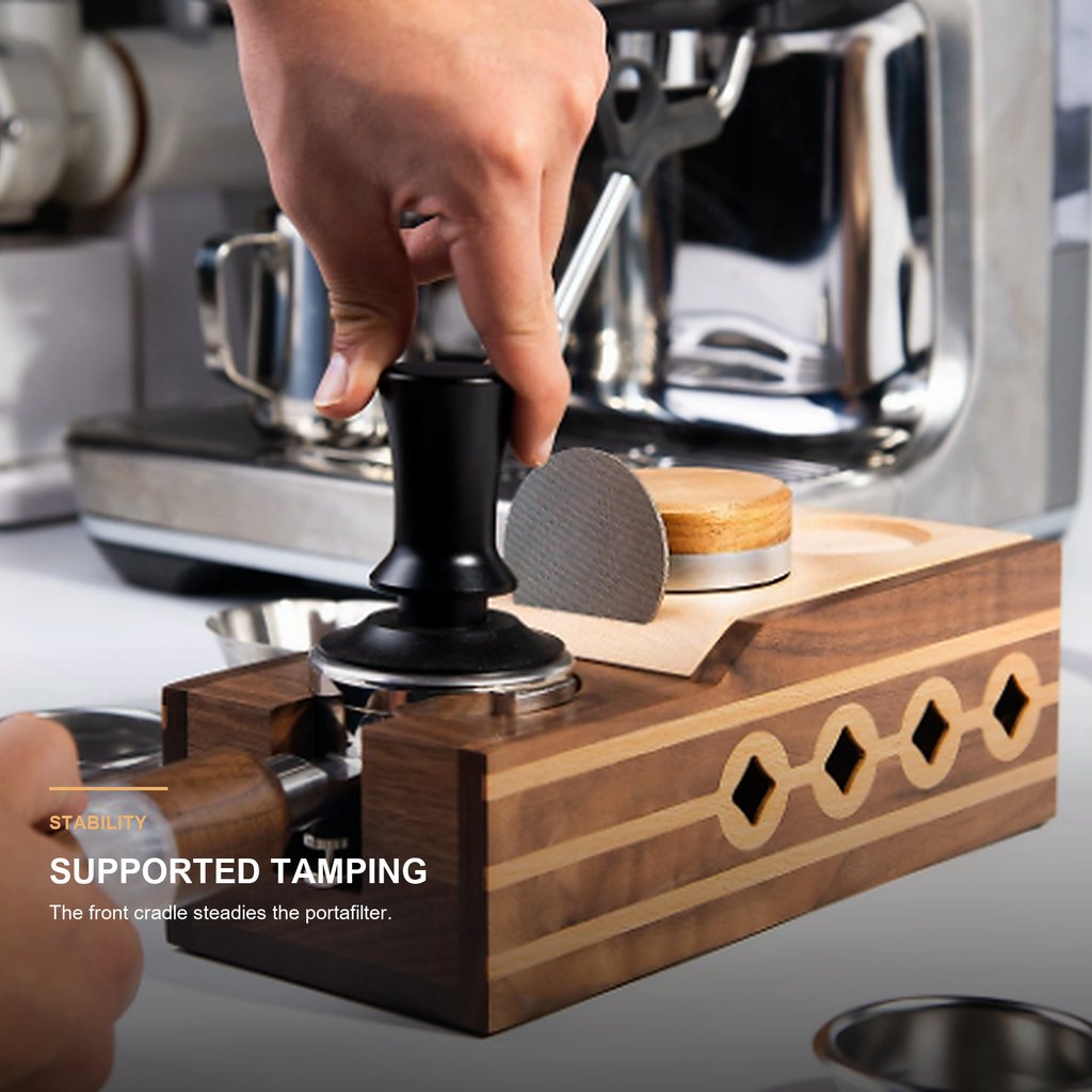 Close-up of supported portafilter tamping on solid walnut station