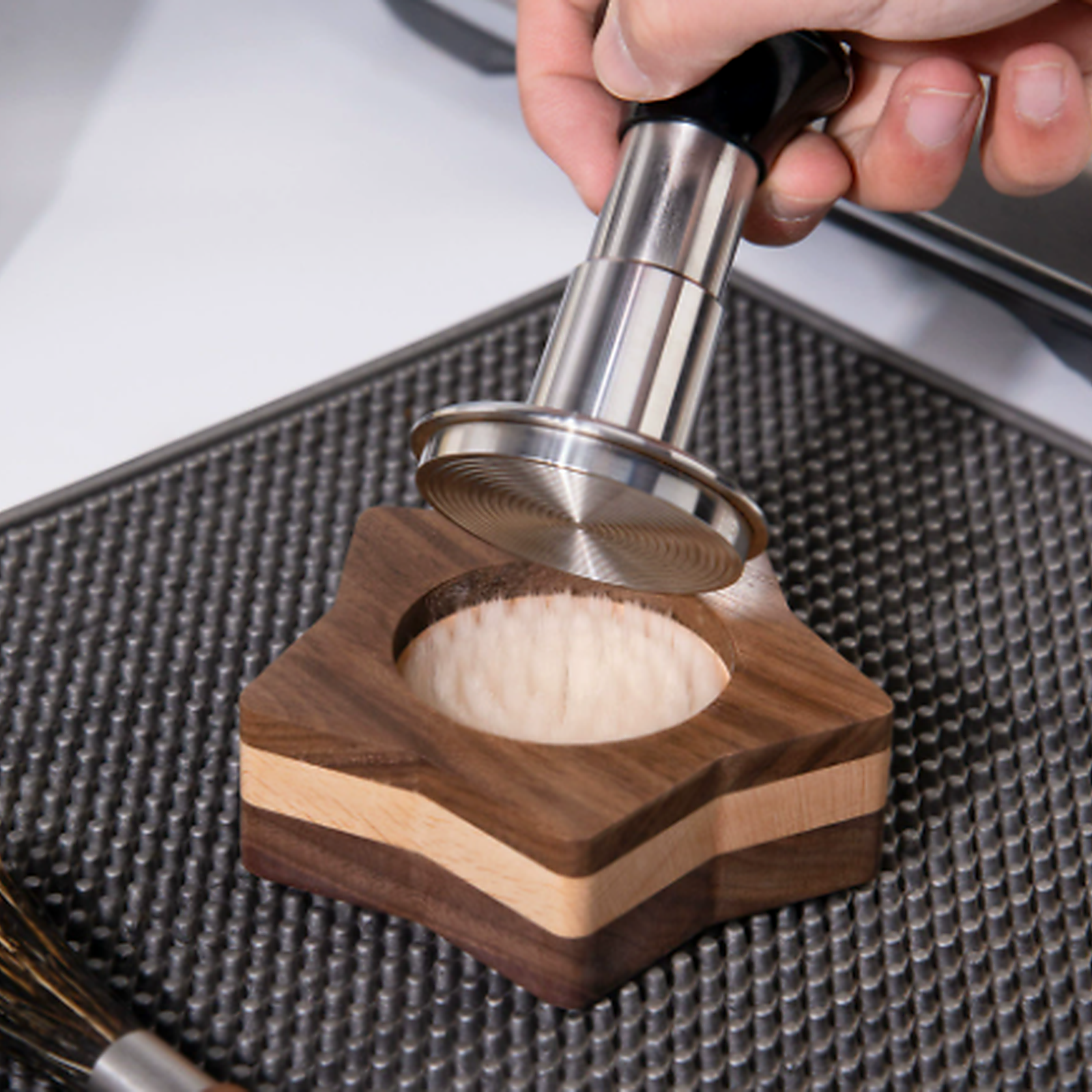 51 and 53 mm espresso cleaning stand brushing coffee grounds from a tamper