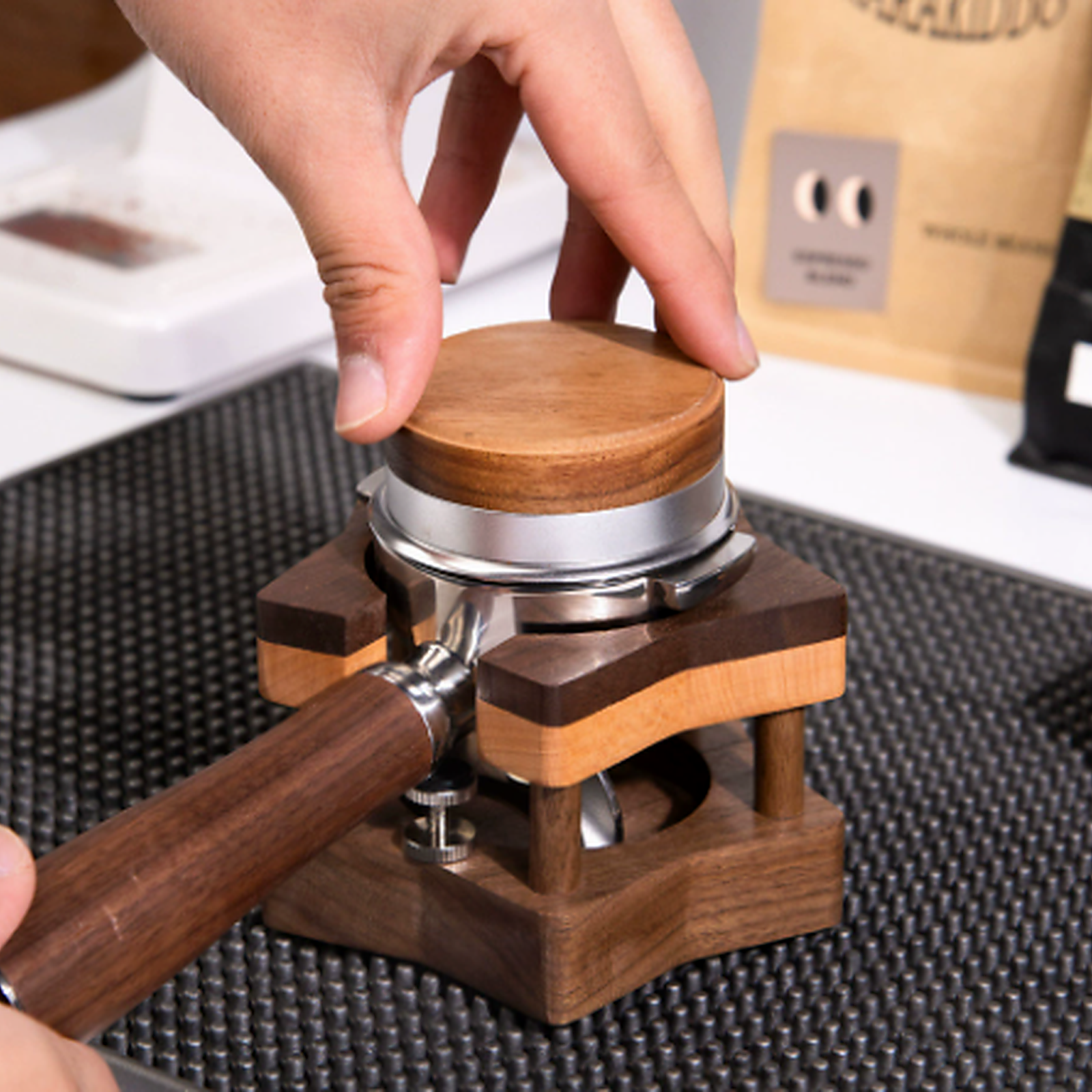 51 and 53 mm solid walnut espresso tamping stand in use