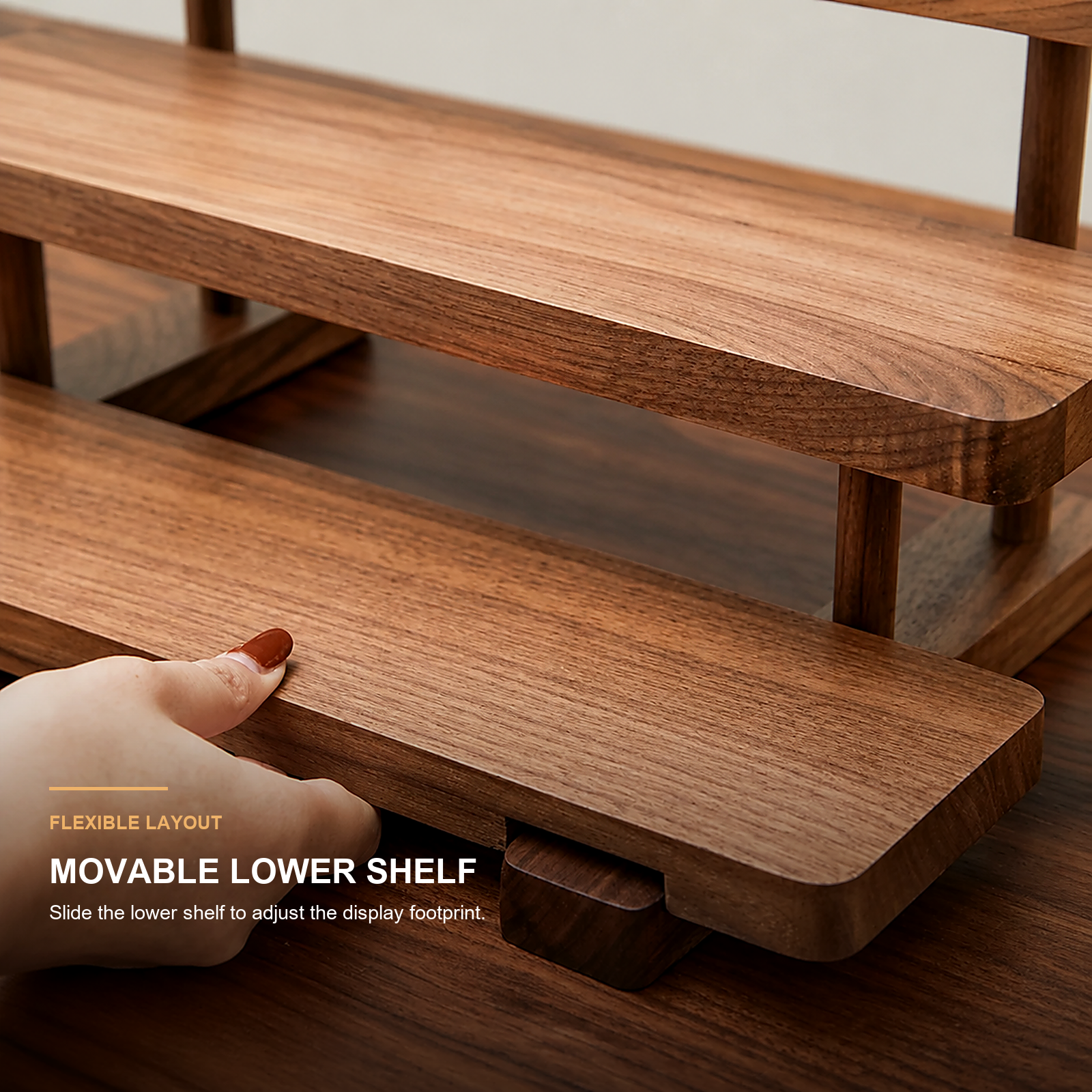 Close-up of movable lower shelf adjusting the display footprint