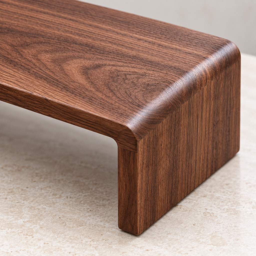 Close-up of the walnut shelf's rounded edge and short solid end support