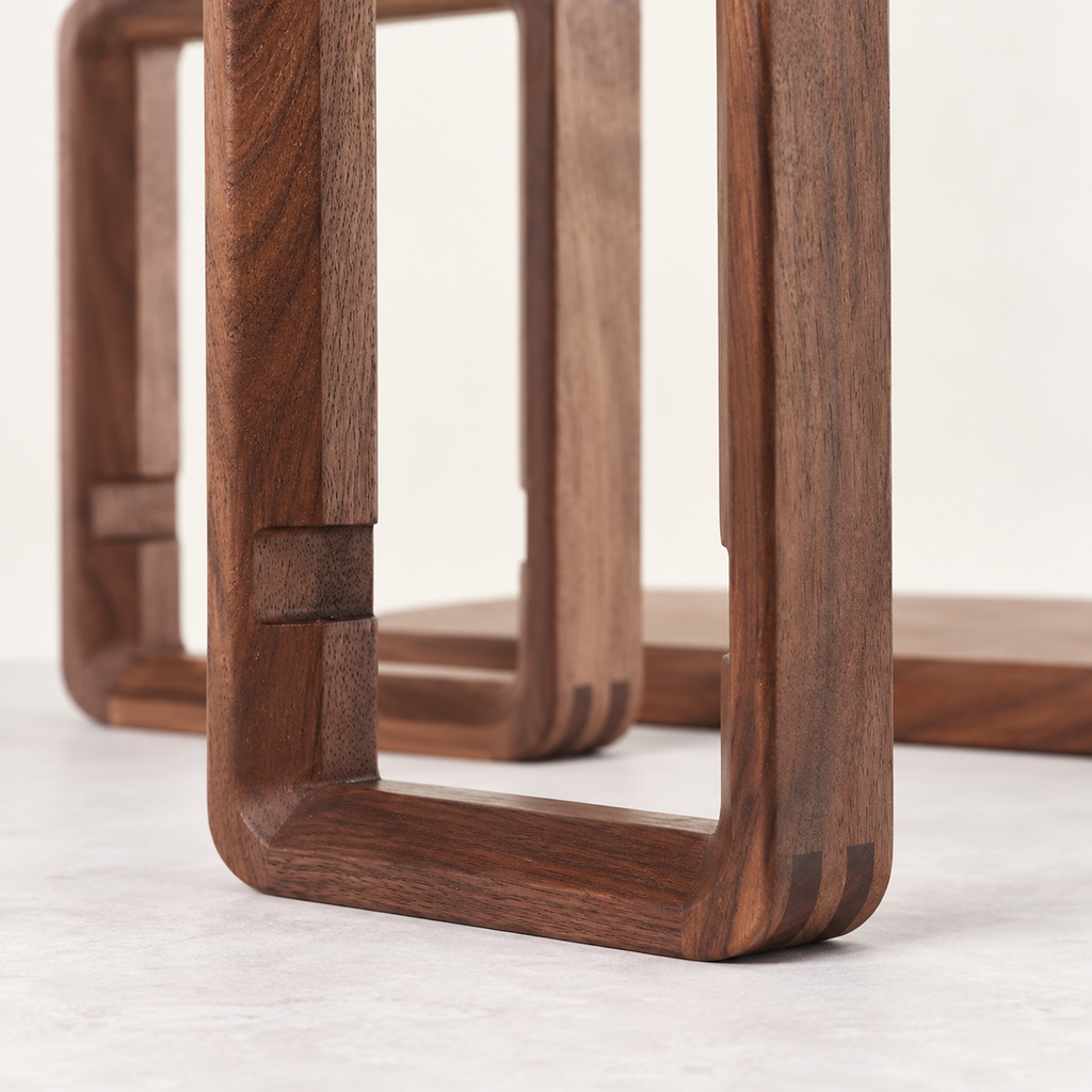 Close-up of the walnut frame's rounded corner and shelf connection slot