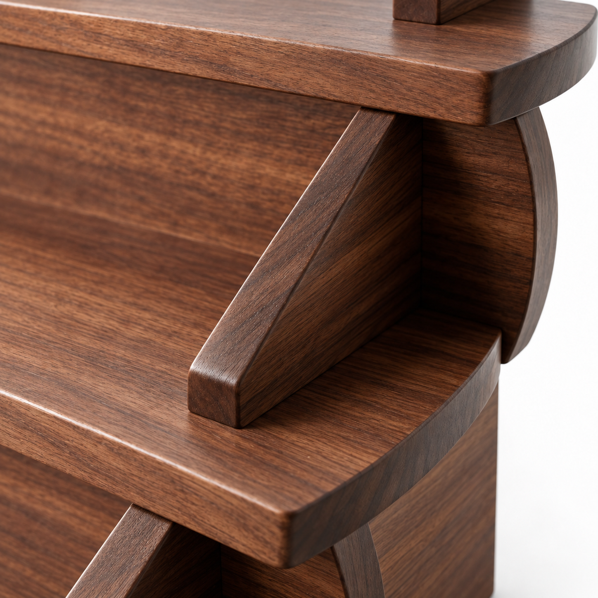Close-up of a walnut triangular side support and rounded shelf edge