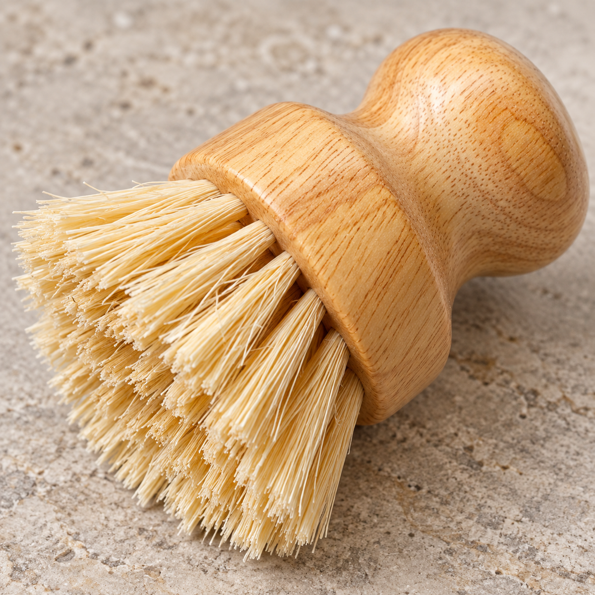 Close-up of natural sisal bristles fitted into the round wooden brush base