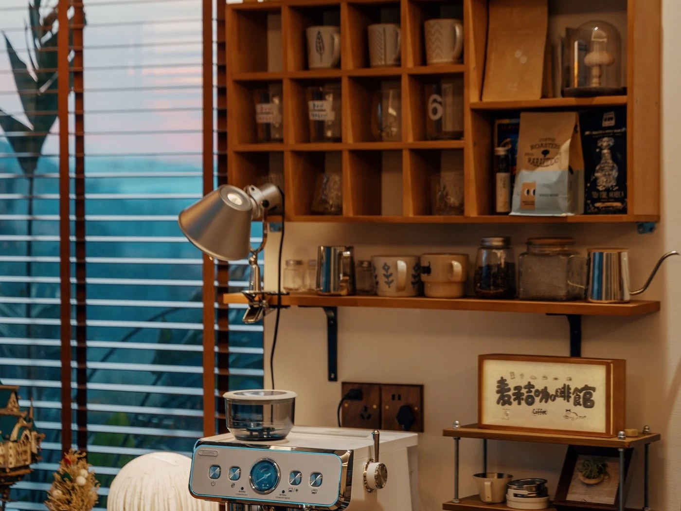 Coffee station with a wooden mug cubby grid positioned above the espresso machine
