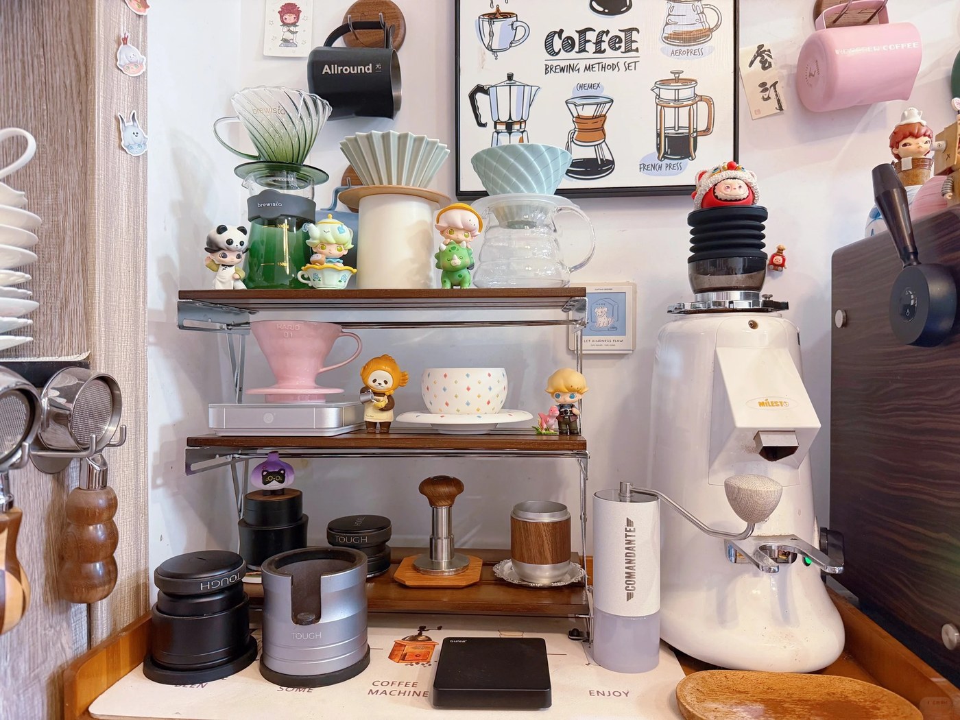 Several manual coffee brewers and cups arranged on one tiered shelf