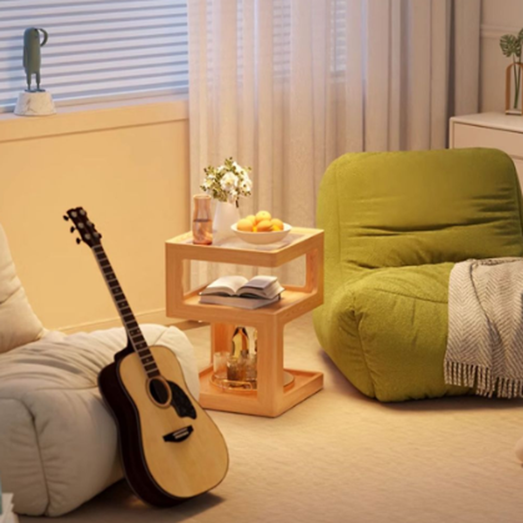 Natural finish three-tier coffee side table in a cozy reading corner