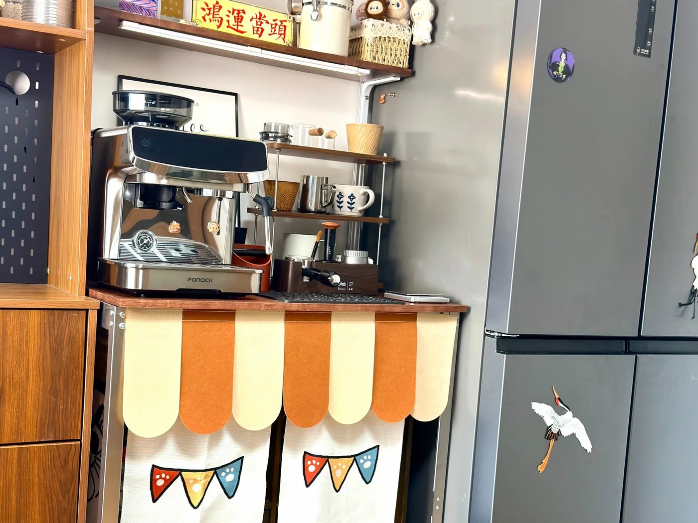 Mug and small containers stored on a shelf between upper storage and espresso equipment